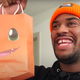 Screenshot of man in orange beanie with trick-or-treat bag
